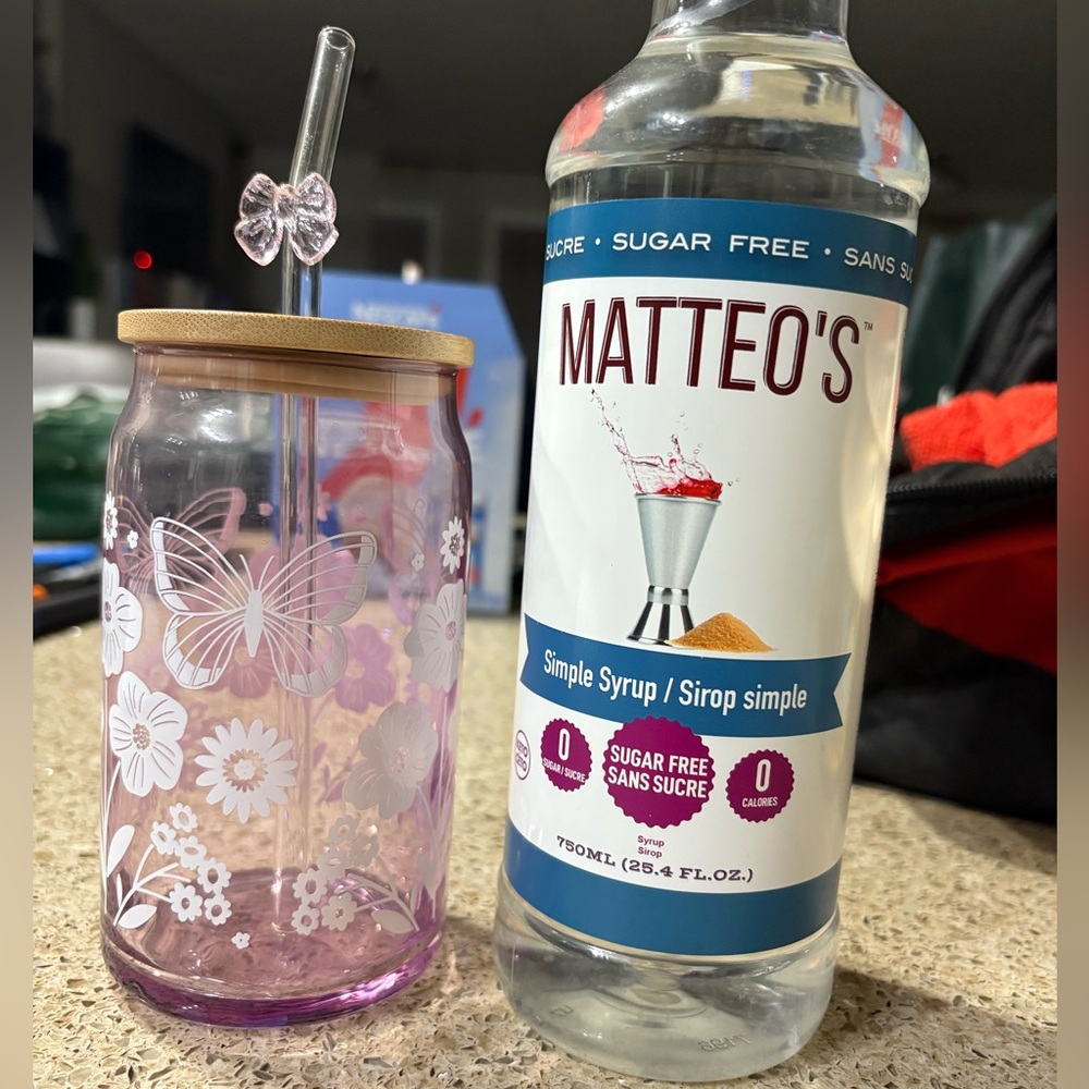 Glass cup with bamboo lid and straw and sealed Matteo’s sugar free simple syrup